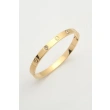 Gold-tone stainless steel bangle with screw motifs design featuring crystal accents
