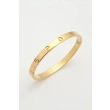 Gold-tone stainless steel bangle with a screw motifs design